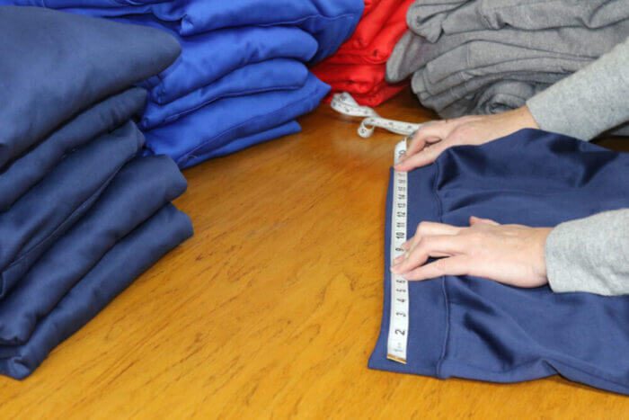 apparel-measurement-inspection-1024x683-1 (1) taking measurements of a trousers weist